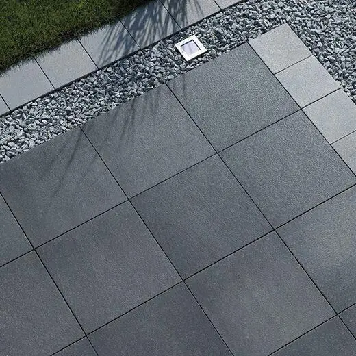 A modern driveway in Abu Dhabi with a two-tone design using dark and light interlocking pavers.